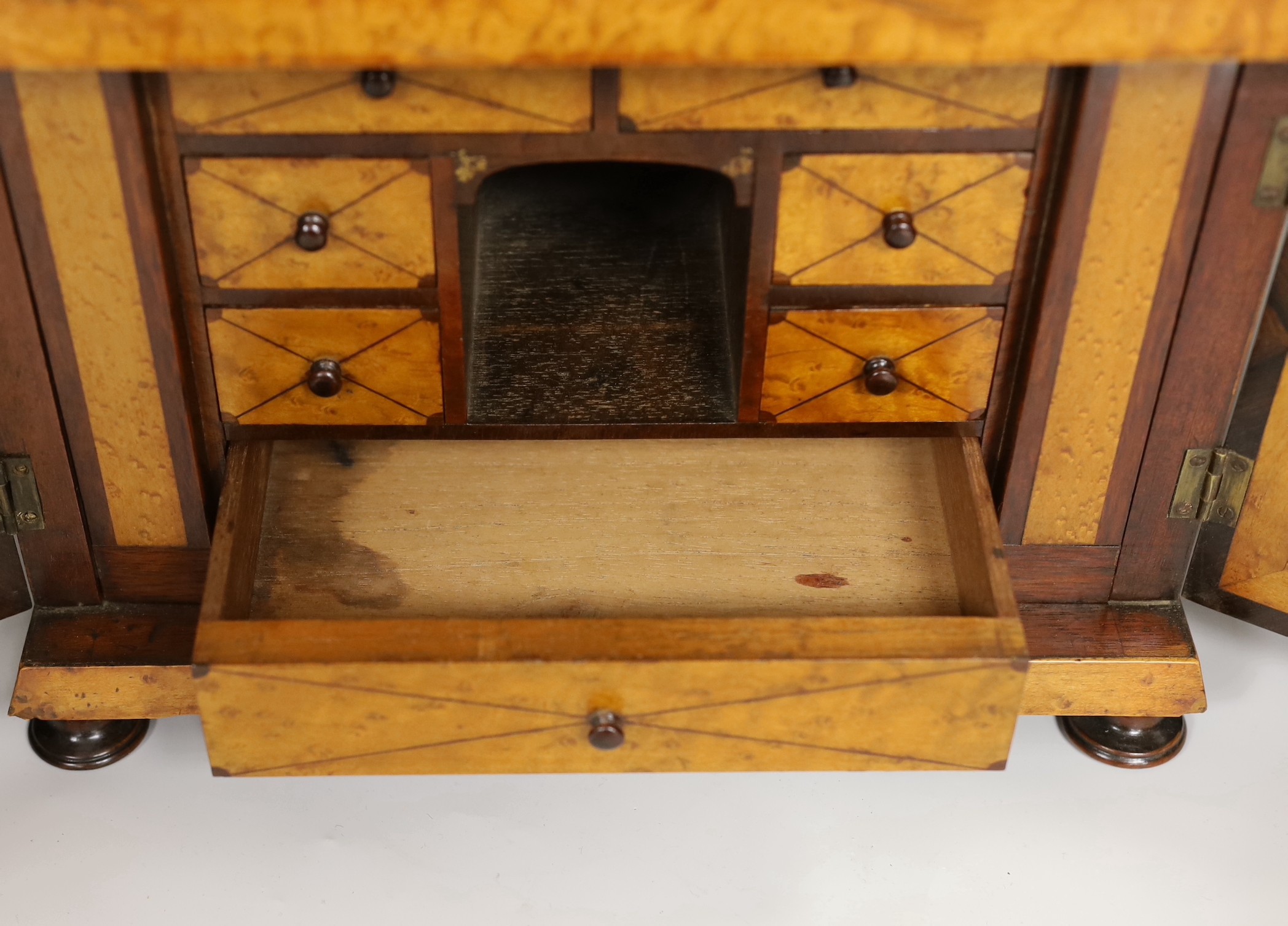 A 19th century rosewood and bird’s eye maple table cabinet. 24cm high. 32cm wide, 23cm deep